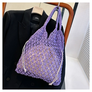 Detail of purple hand-woven cotton mesh tote bag with a cream drawstring inner pouch