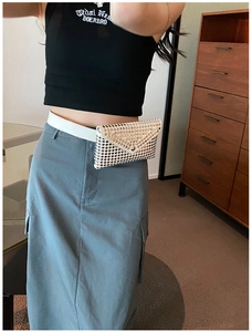 White leather belt bag with silver rivets styled on model for punk fashion look