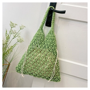 Macro detail of grass green macrame knit tote bag with cream drawstring lining
