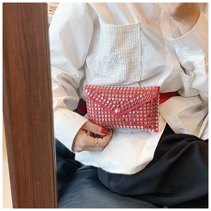 Detail of red punk waist bag with silver studs and metal clasp on thin belt