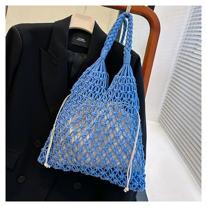 Close-up of blue hand-woven cotton rope tote bag with mesh design and cream drawstring liner