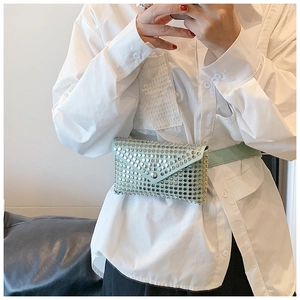 Detail of mint green punk style waist bag with silver rivets and matching leather belt