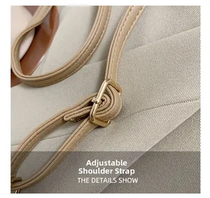 Detail showing adjustable apricot leather shoulder strap with gold metal buckle