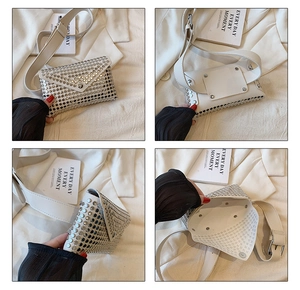 Detail view of cream punk envelope bag featuring silver rivets and wide shoulder strap