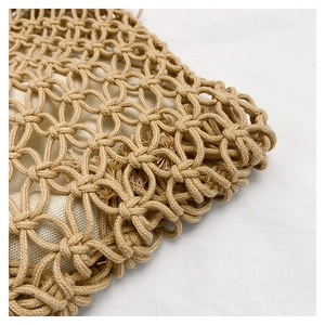 Detail of khaki cotton woven bag showing hollow crochet patterns and white fabric lining