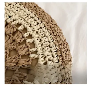 Detail showing two-tone khaki and beige handmade woven texture of a straw bag