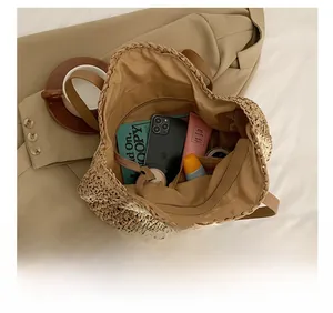 Interior view showing the large capacity and fabric lining of this woven straw tote bag