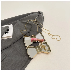Detailed view of the golden butterfly acrylic mini bag with mirror and lipstick storage