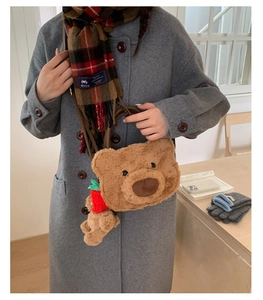 Close-up of fluffy brown teddy bear plush bag with a cute carrot charm accessory