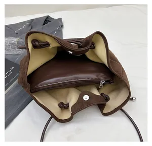 Detail of dark brown suede bucket bag interior with a matching removable inner pouch