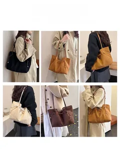 Detail view of large faux suede tote bags in black, caramel, cream, and brown colors