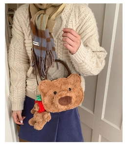 Detail of plush bear bag with faux fur texture and a cute strawberry bear charm
