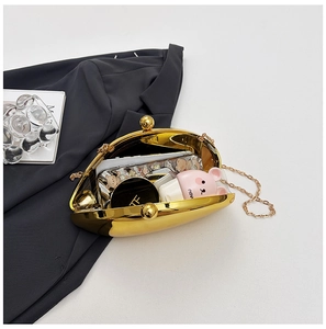 Detail of golden shell evening bag showing interior capacity for phone and cosmetics