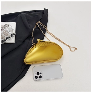 Detail view of gold mirror finish evening clutch with chain strap and phone for size reference