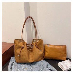 Brown faux suede tote bag and matching zippered pouch on denim background