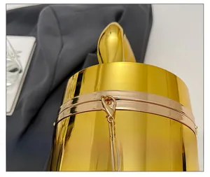 Detailed macro view of the gold-plated cylindrical clutch with precision metal hinge