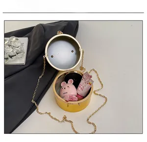 Internal capacity of the gold acrylic clutch bag holding lipstick and cosmetics
