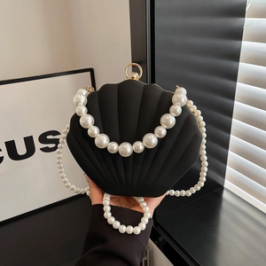 Elegant black shell-shaped acrylic evening bag with pearl handle and long strap