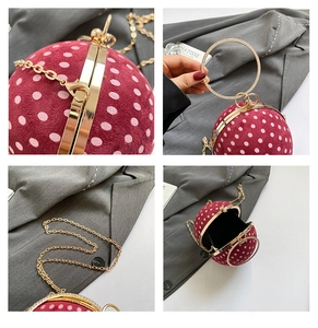 Detail view of the red polka dot ball bag featuring a crystal-encrusted ring handle