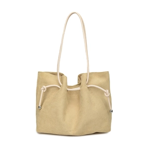 Detail of suede tote bag featuring slender rope straps and silver metal ball accents