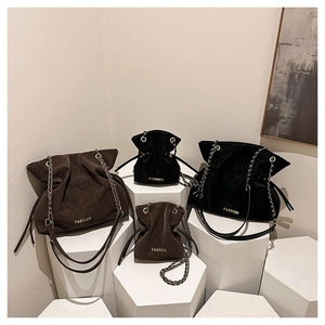 Detailed comparison of vintage velvet bucket bags in black and brown with chain straps