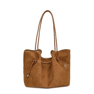 Detail view of caramel brown faux suede tote bag with side drawstring and metal beads