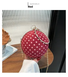 Chic red sphere evening bag with white polka dots, gold metal ring handle and chain strap