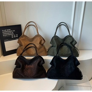 Detailed display of four colorful tote bags in camel, olive, brown and black finishes