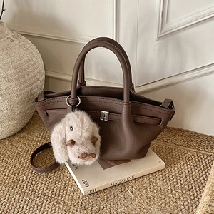 Dark brown leather bucket bag with silver buckle and cute plush rabbit charm