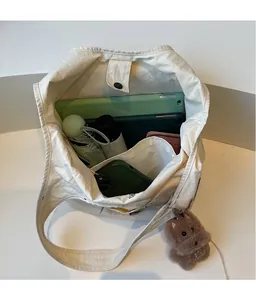Top view of cream canvas tote bag interior showing large capacity with daily essentials
