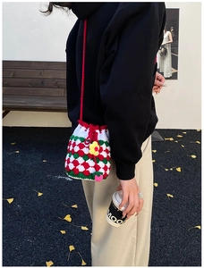 Detailed handmade crochet bucket bag with red flower detail and plaid knit pattern