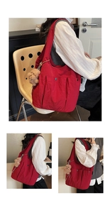 Detailed side view of red nylon tote bag with pleated pockets and plush bear charm