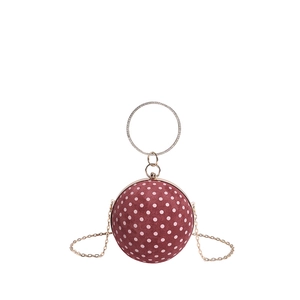 Red polka dot sphere evening bag with diamond ring handle and gold chain strap