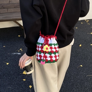 Handmade crochet bucket bag with red checkerboard pattern and yellow flower detail