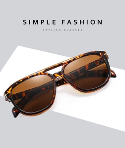 Detailed close-up of stylish tortoise shell double bridge sunglasses with brown lenses