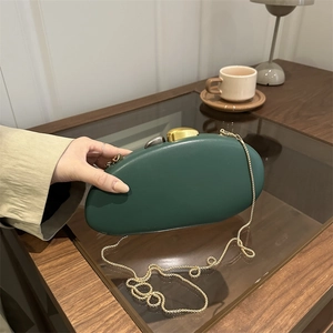Elegant dark green oval acrylic clutch bag with golden metal clasp and chain strap