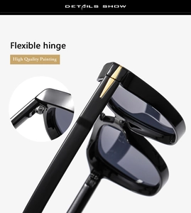 Detail showing flexible hinges and premium glossy black finish on double bridge sunglasses
