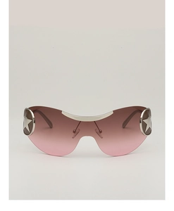 Close-up of Y2K pilot sunglasses featuring a pink gradient lens and silver star detail