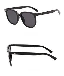 Detail view of black square sunglasses featuring silver rivets and dark grey lenses
