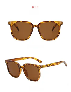 Detail view of amber tortoise sunglasses with dark brown lenses and silver rivets