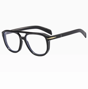Close-up of black double bridge aviator sunglasses featuring gold arrow metal hinges