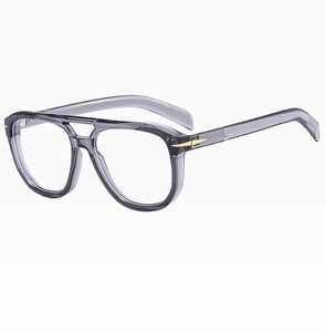 Detail of oversized pilot sunglasses featuring translucent grey frames and gold arrow hinges