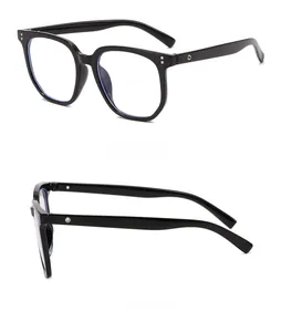 Detail view of glossy black large frame glasses with silver rivets and metal hinges