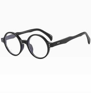 Détail de profil de lunettes de soleil rondes noires vintage avec rivets argentés sur cadre