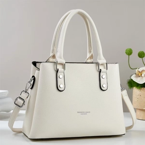 Minimalist white lychee leather tote bag with silver hardware for chic commuting style