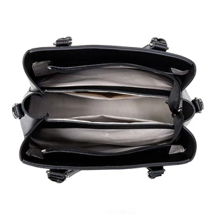 Interior view of large capacity tote bag featuring multi-compartment design and silver hardware