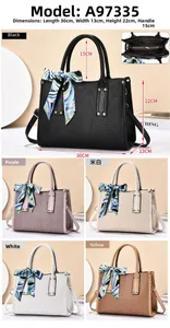 Detailed view of woven texture tote bag with dimensions and silk scarf handle accent