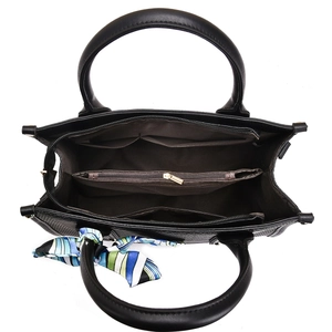 Internal view of black tote bag showing three-layer compartments and silk scarf detail