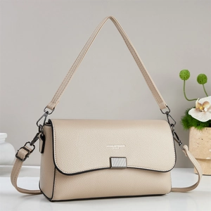 Cream vintage baguette shoulder bag with pebbled leather texture and dual straps