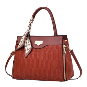 Fashionable burgundy leather shoulder bag with embossed texture and silk scarf detail